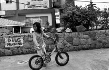 grayscale photo of girl holding bike